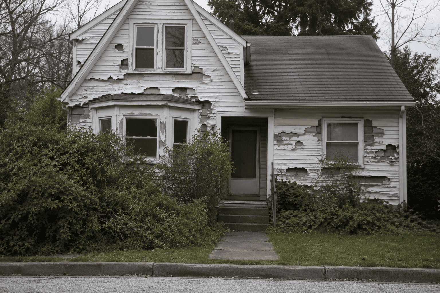 severely damaged and deteriorating vinyl siding