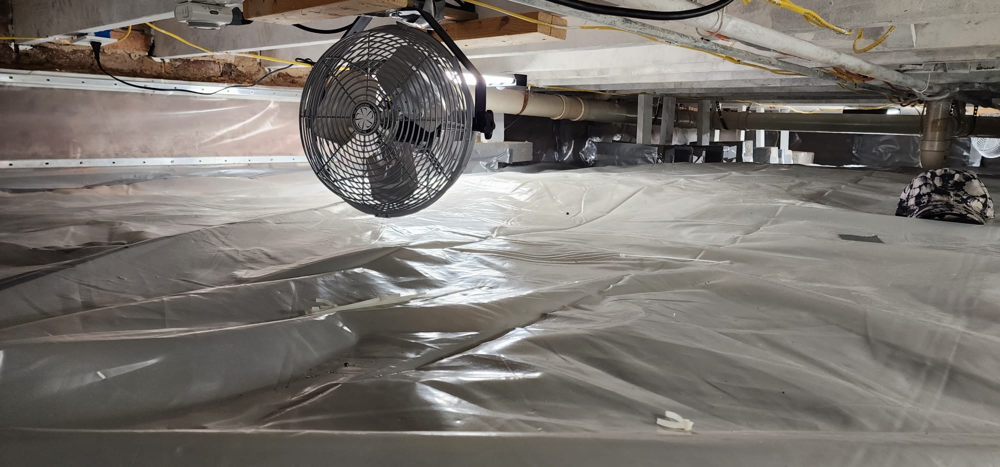 Air circulation fan installed in a crawl space
