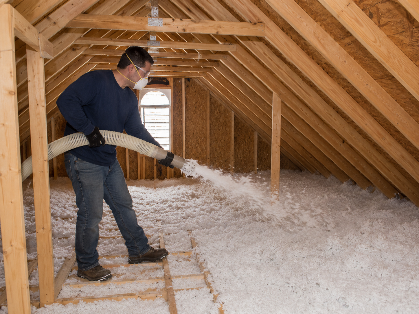 Technician installing blown-in attic insulation in an Odenton, Maryland home