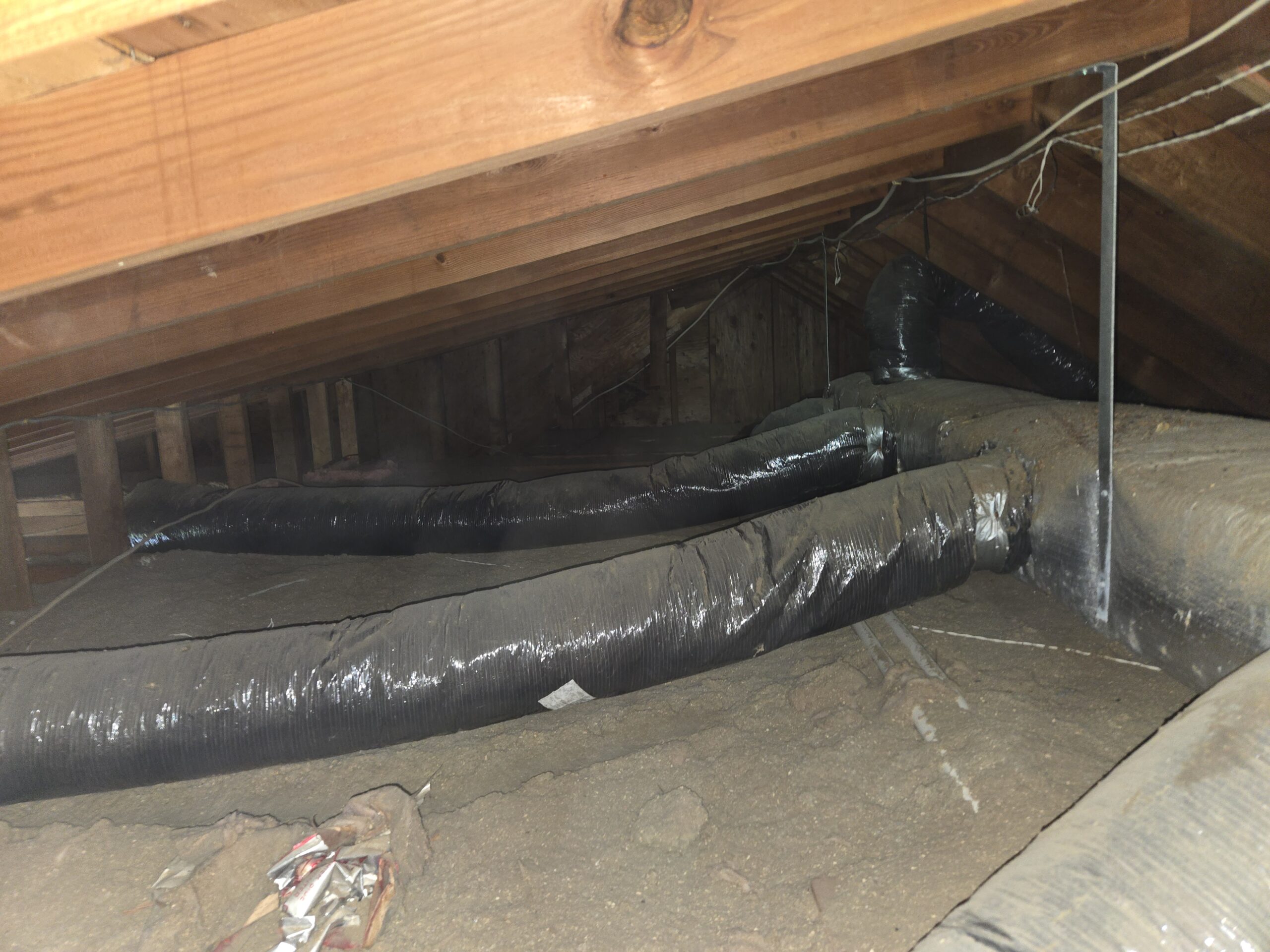 Old attic insulation before professional removal