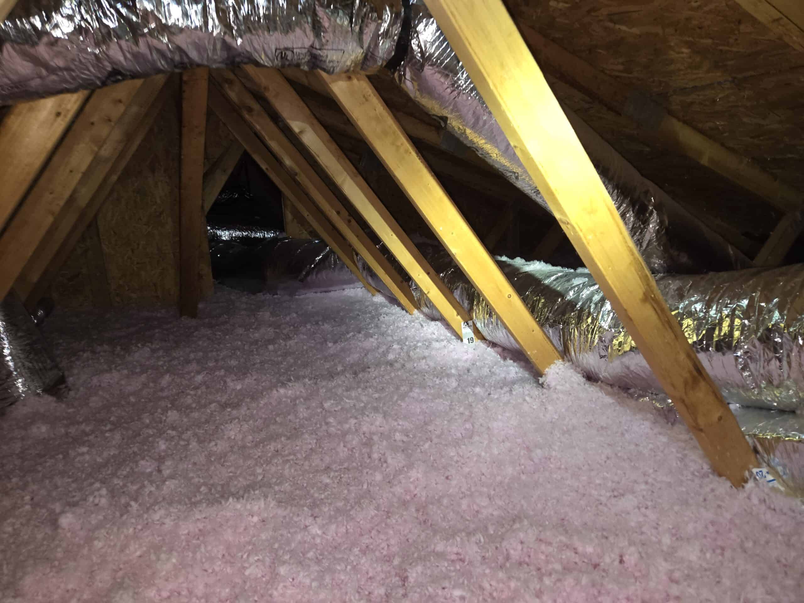 Old attic insulation and debris exposed during an insulation removal project in Ellicott City, Maryland
