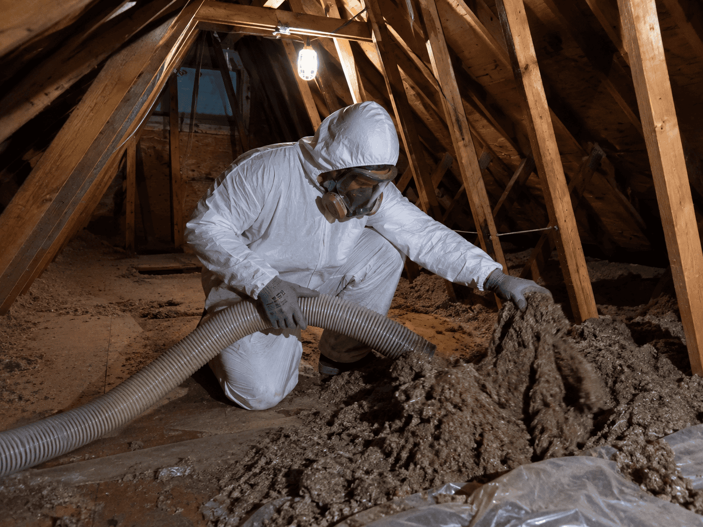 Technician working on attic insulation removal and restoration in Columbia, Maryland