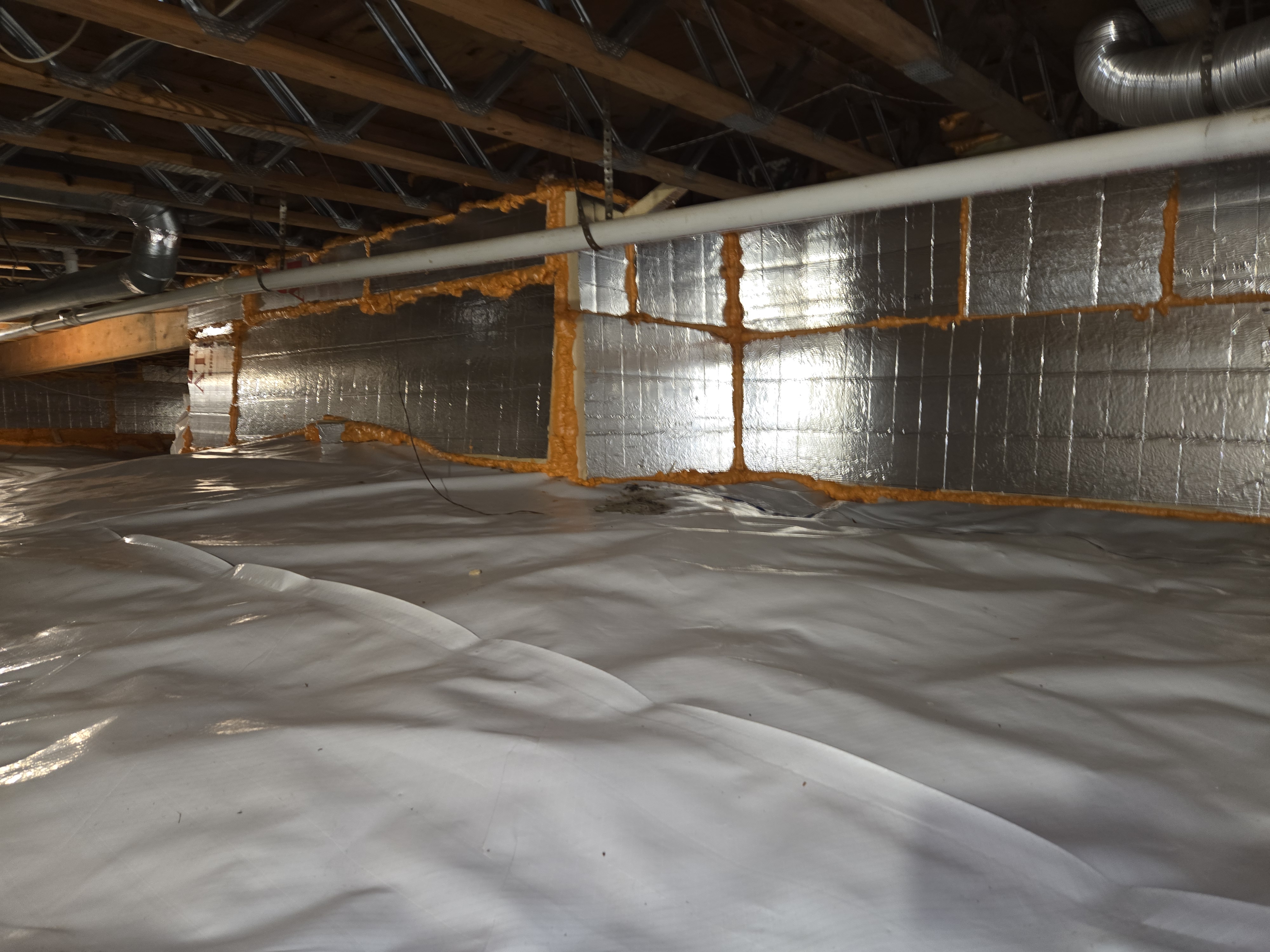 Encapsulated crawl space with insulated foundation walls, sealed seams and a reinforced floor liner in Maryland